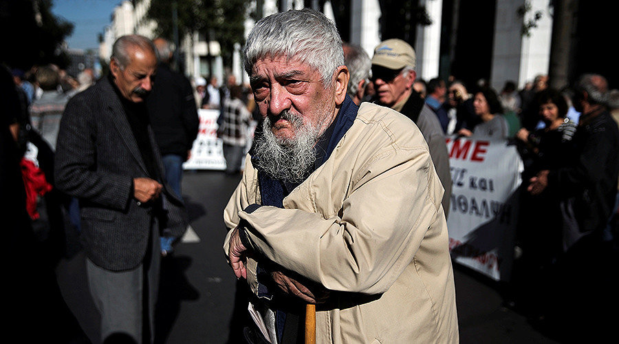Greek pensioner leans on a shepherd's crook at protest pension cuts athens